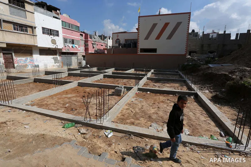 Palestinian children stand near the building columns for their families houses , destroyed during 2014 war, in Shijaiyah neighborhood in the east of Gaza city on Feb. 11, 2016. Rebuilding of Palestinian houses which dest...