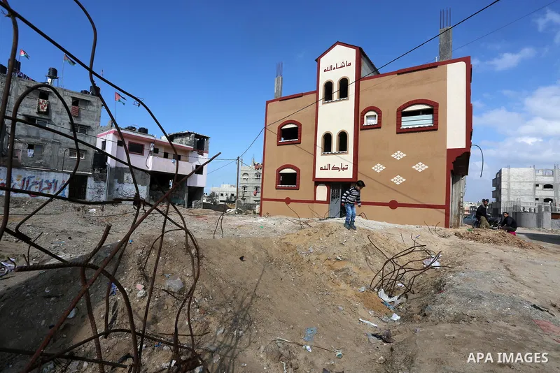 Palestinian children play in front of the remains of a house, destroyed during 2014 war, in Shijaiyah neighborhood in the east of Gaza city on Feb. 11, 2016. Rebuilding of Palestinian houses which destroyed during 2014 w...