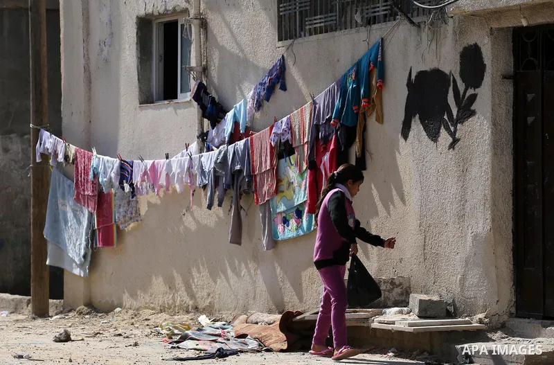 A Palestinian girl walks past a house wihch destroyed during 2014 war, in Shijaiyah neighborhood in the east of Gaza city on Feb. 11, 2016. Rebuilding of Palestinian houses which destroyed during 2014 war and funded by K...