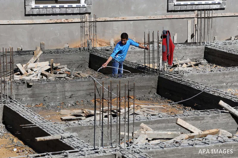 Palestinian children stand near the building columns for their families houses , destroyed during 2014 war, in Shijaiyah neighborhood in the east of Gaza city on Feb. 11, 2016. Rebuilding of Palestinian houses which dest...