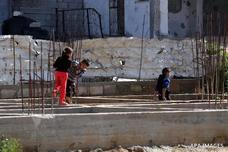 Palestinian children stand near the building columns for their families houses , destroyed during 2014 war, in Shijaiyah neighborhood in the east of Gaza city on Feb. 11, 2016. Rebuilding of Palestinian houses which dest...