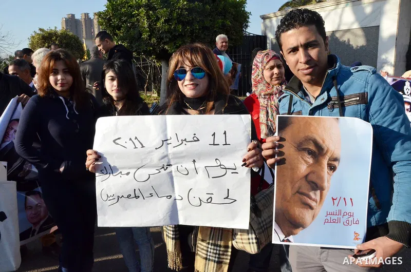 Supporters of Egypt's former president Hosni Mubarak take part during a protest to show solidarity with him outside the Maadi military hospital in Cairo on Feb. 11, 2016. Photo by Amr Sayed