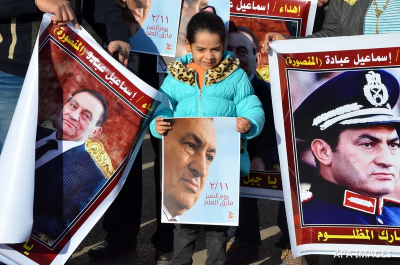 Supporters of Egypt's former president Hosni Mubarak take part during a protest to show solidarity with him outside the Maadi military hospital in Cairo on Feb. 11, 2016. Photo by Amr Sayed