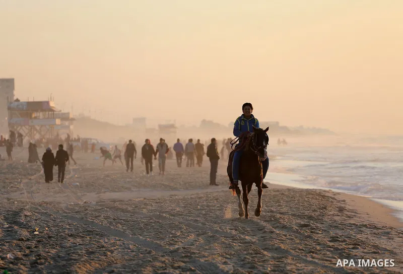 A Palestinian youth shows his skills on rides horses on the beach of Gaza city on Feb. 12, 2016. Photo by Mohammed Asad