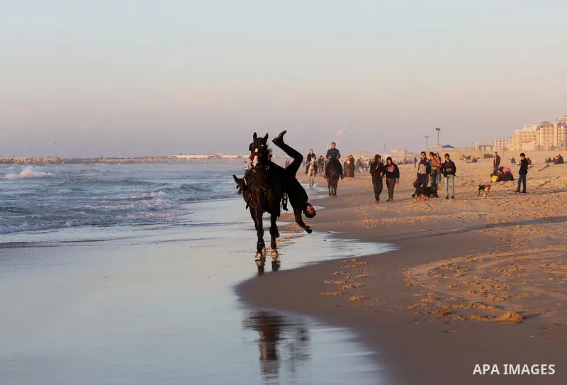 A Palestinian youth shows his skills on rides horses on the beach of Gaza city on Feb. 12, 2016. Photo by Mohammed Asad