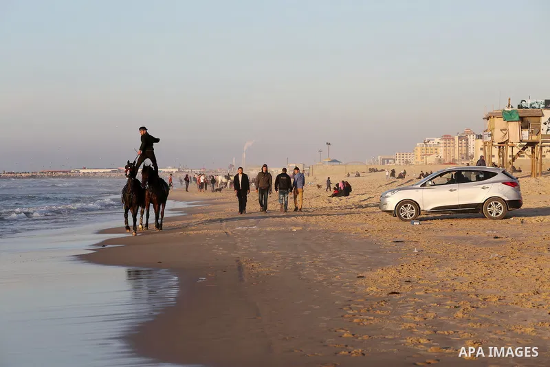 A Palestinian youth shows his skills on rides horses on the beach of Gaza city on Feb. 12, 2016. Photo by Mohammed Asad