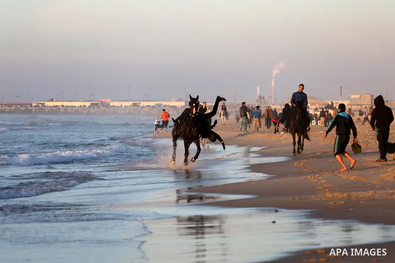 Palestinian youths show their skills on ride horses on the beach of Gaza city on Feb. 12, 2016. Photo by Mohammed Asad