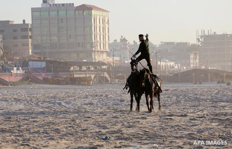 A Palestinian youth shows his skills on rides horses on the beach of Gaza city on Feb. 12, 2016. Photo by Mohammed Asad