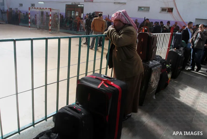 Palestinians await permission to enter Egypt as they gather at the Rafah border crossing in the southern Gaza Strip on February 13, 2016. The Gaza Strip's border crossing with Egypt at Rafah is set to reopen for two days...