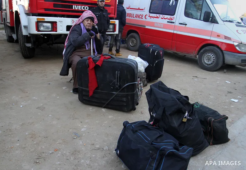 Palestinians await permission to enter Egypt as they gather at the Rafah border crossing in the southern Gaza Strip on February 13, 2016. The Gaza Strip's border crossing with Egypt at Rafah is set to reopen for two days...