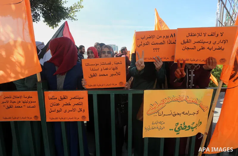 Palestinians hold posters during a protest in support of hunger striking Palestinian journalist Mohammed al-Qiq, in Gaza city on February 13, 2016. The 33-year-old television reporter will keep up his 10-week hunger stri...