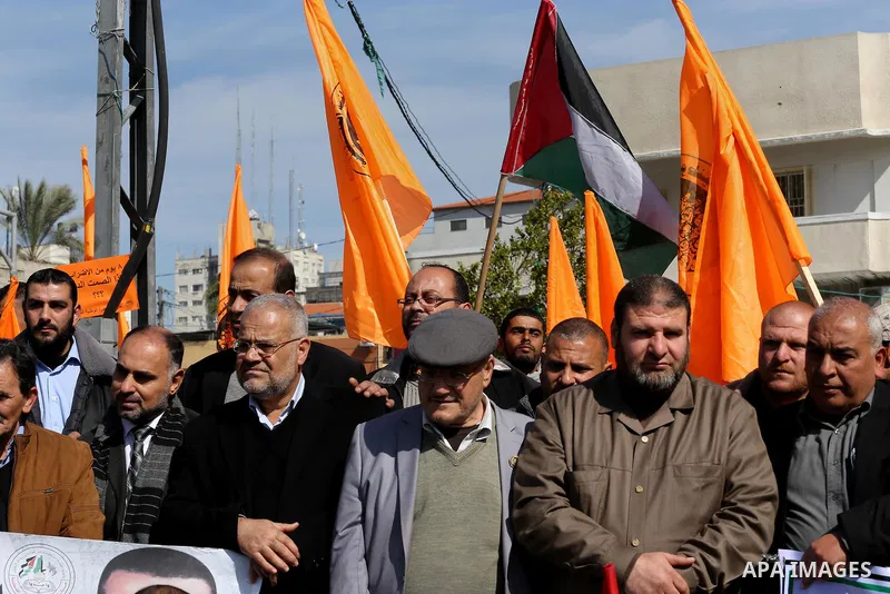 Palestinians hold posters during a protest in support of hunger striking Palestinian journalist Mohammed al-Qiq, in Gaza city on February 13, 2016. The 33-year-old television reporter will keep up his 10-week hunger stri...