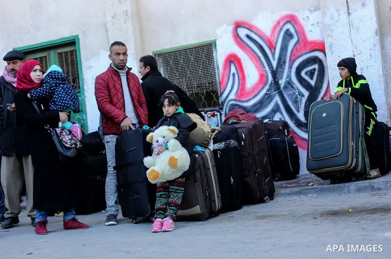 Palestinians await permission to enter Egypt as they gather at the Rafah border crossing in the southern Gaza Strip on February 13, 2016. The Gaza Strip's border crossing with Egypt at Rafah is set to reopen for two days...