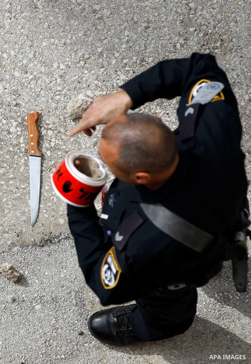 Israeli security forces carry the body of a Palestinian woman tried to stab an Israeli soldier before being shot dead, in the Israeli occupied West Bank city of Hebron, on February 13, 2016. An Israeli army statement sai...