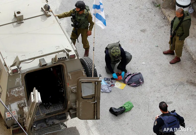 Israeli security forces carry the body of a Palestinian woman tried to stab an Israeli soldier before being shot dead, in the Israeli occupied West Bank city of Hebron, on February 13, 2016. An Israeli army statement sai...