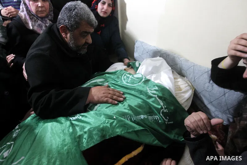 Palestinian relatives react next to the body of 17-year-old woman Kilzar Owaiwi, who was shot dead by Israeli troops after the troops said she attempted to stab an Israeli soldier, in the West Bank city of Hebron Februar...