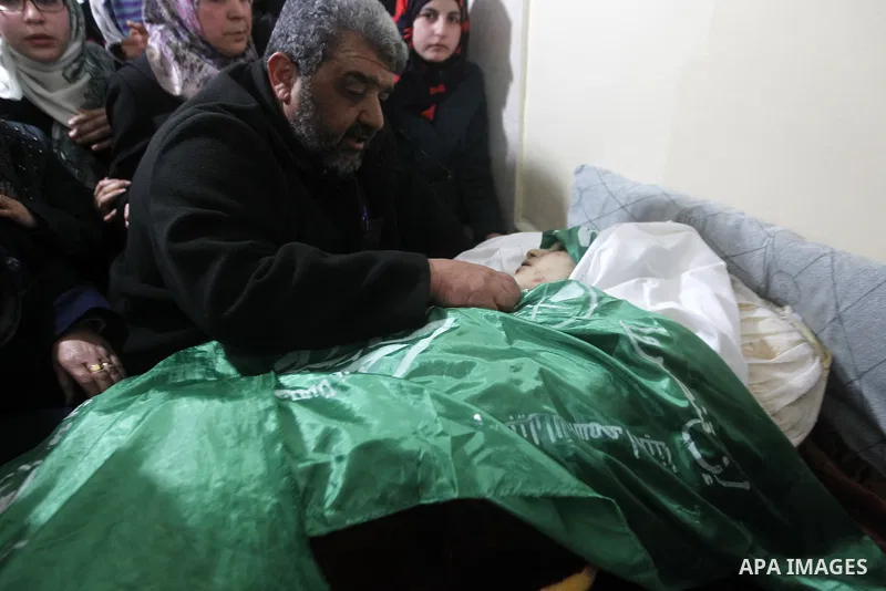 Palestinian relatives react next to the body of 17-year-old woman Kilzar Owaiwi, who was shot dead by Israeli troops after the troops said she attempted to stab an Israeli soldier, in the West Bank city of Hebron Februar...