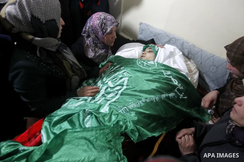 Palestinian relatives react next to the body of 17-year-old woman Kilzar Owaiwi, who was shot dead by Israeli troops after the troops said she attempted to stab an Israeli soldier, in the West Bank city of Hebron Februar...