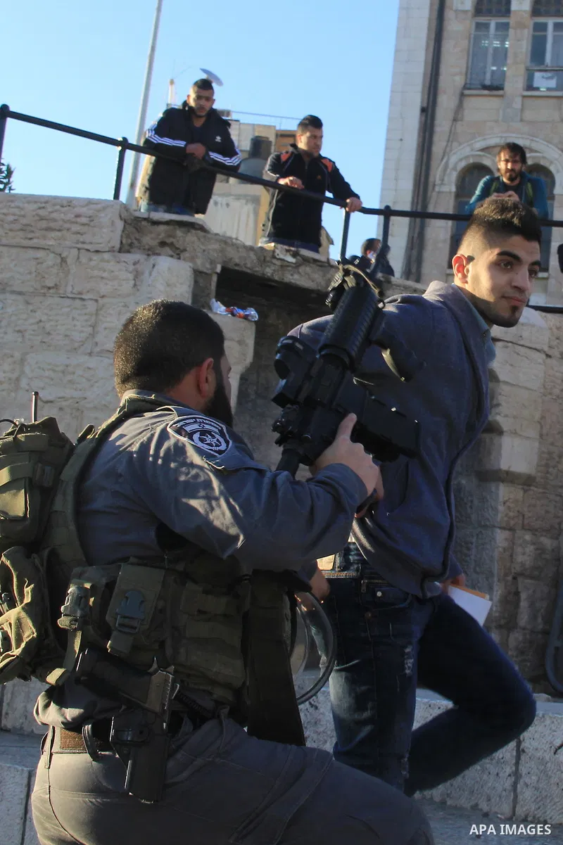 Israeli policemen detain a Palestinian man at Damascus Gate, a main entrance to Jerusalem's Old City on February 13, 2016. Photo by Mahfouz Abu Turk