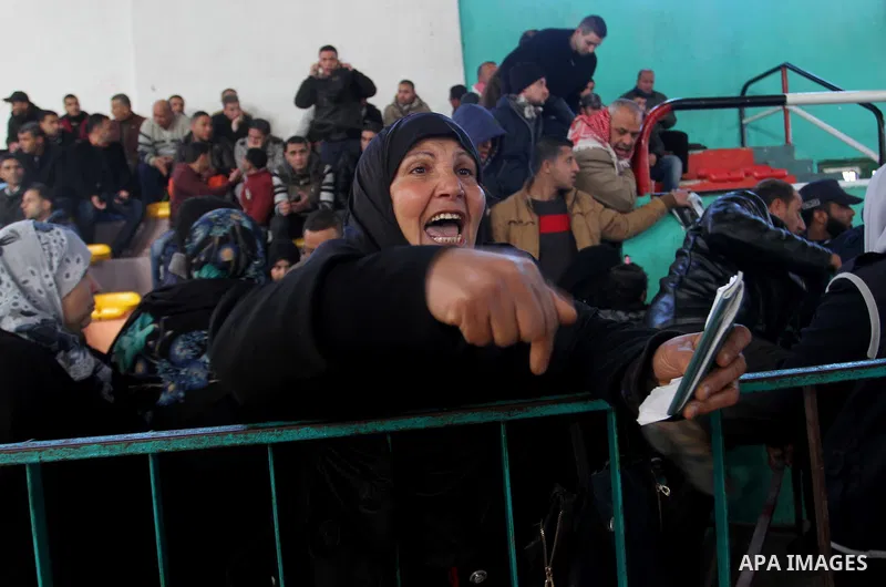 A woman reacts as she waits for a travel permit to cross into Egypt through the Rafah border crossing between Egypt and the southern Gaza Strip February 14, 2016. Egypt opened the Rafah border crossing on Saturday for tw...
