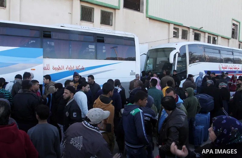 Palestinians wait for a travel permit to cross into Egypt through the Rafah border crossing between Egypt and the southern Gaza Strip February 14, 2016. Egypt opened the Rafah border crossing on Saturday for two days to...