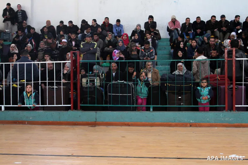 Palestinians wait for a travel permit to cross into Egypt through the Rafah border crossing between Egypt and the southern Gaza Strip February 14, 2016. Egypt opened the Rafah border crossing on Saturday for two days to...
