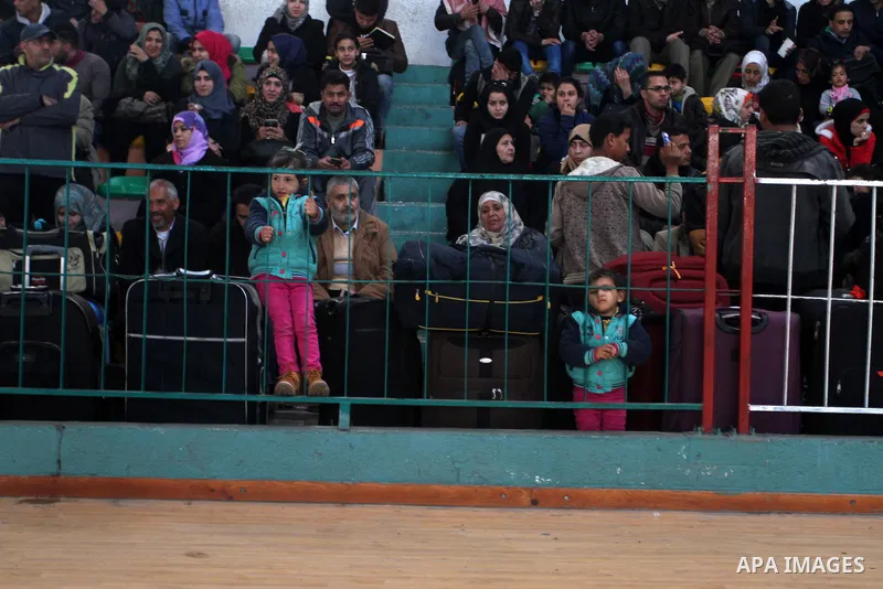 Palestinians wait for a travel permit to cross into Egypt through the Rafah border crossing between Egypt and the southern Gaza Strip February 14, 2016. Egypt opened the Rafah border crossing on Saturday for two days to...