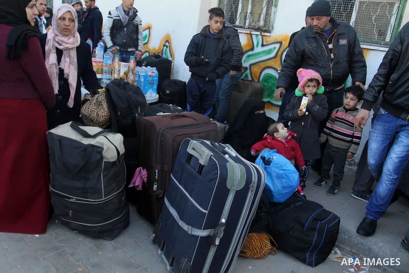 Palestinians wait for a travel permit to cross into Egypt through the Rafah border crossing between Egypt and the southern Gaza Strip February 14, 2016. Egypt opened the Rafah border crossing on Saturday for two days to...