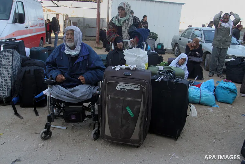 Palestinians wait for a travel permit to cross into Egypt through the Rafah border crossing between Egypt and the southern Gaza Strip February 14, 2016. Egypt opened the Rafah border crossing on Saturday for two days to...
