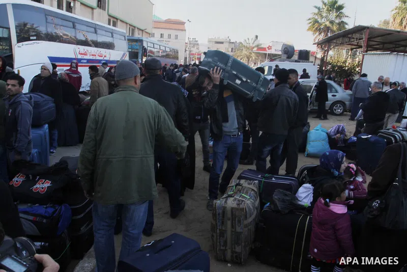 Palestinians wait for a travel permit to cross into Egypt through the Rafah border crossing between Egypt and the southern Gaza Strip February 14, 2016. Egypt opened the Rafah border crossing on Saturday for two days to...