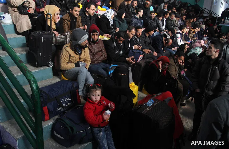 Palestinians wait for a travel permit to cross into Egypt through the Rafah border crossing between Egypt and the southern Gaza Strip February 14, 2016. Egypt opened the Rafah border crossing on Saturday for two days to...