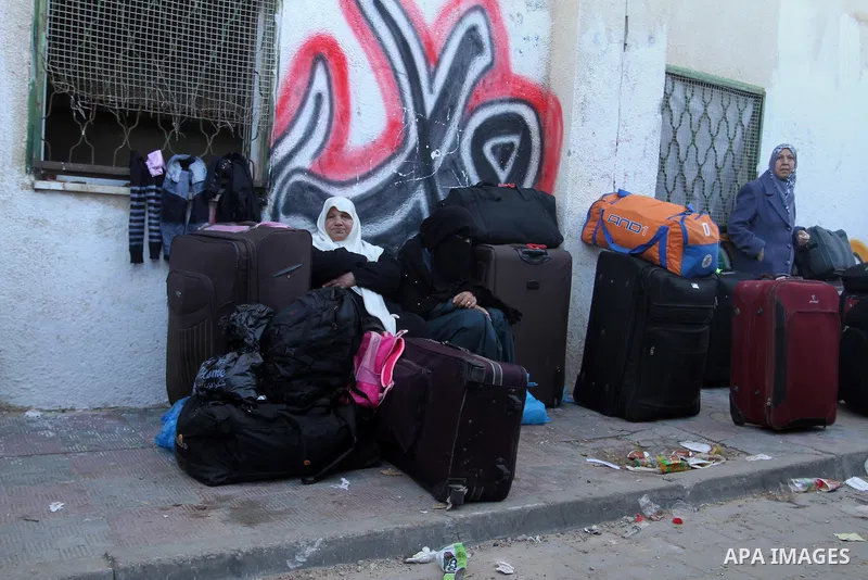 Palestinians wait for a travel permit to cross into Egypt through the Rafah border crossing between Egypt and the southern Gaza Strip February 14, 2016. Egypt opened the Rafah border crossing on Saturday for two days to...