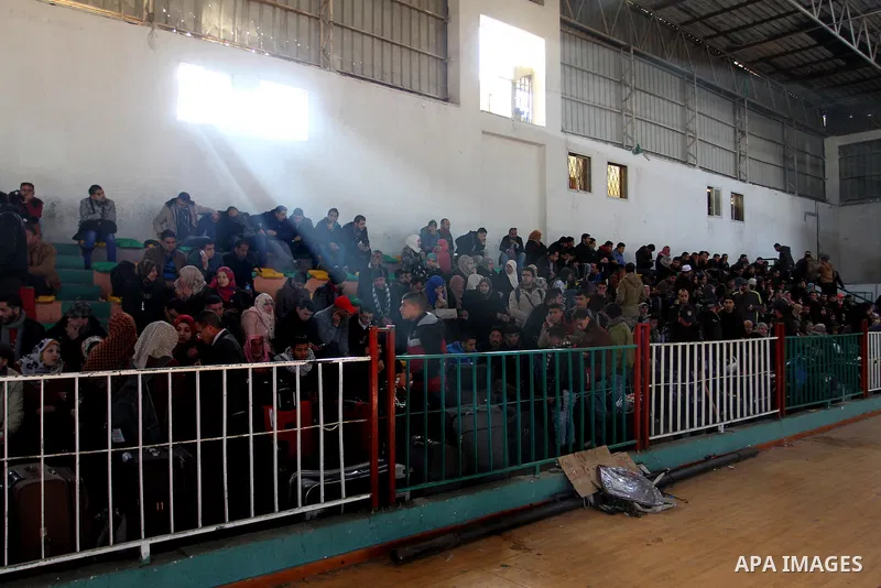 Palestinians wait for a travel permit to cross into Egypt through the Rafah border crossing between Egypt and the southern Gaza Strip February 14, 2016. Egypt opened the Rafah border crossing on Saturday for two days to...