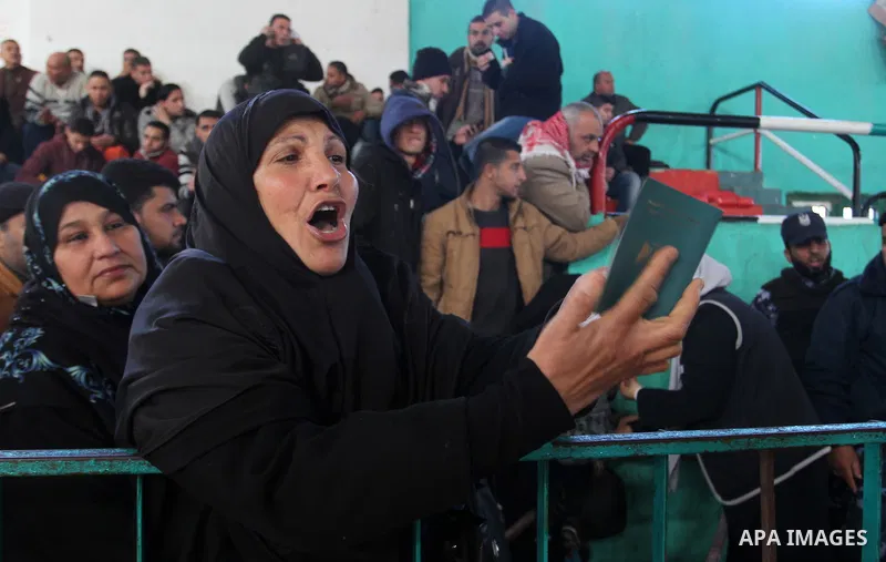 A woman reacts as she waits for a travel permit to cross into Egypt through the Rafah border crossing between Egypt and the southern Gaza Strip February 14, 2016. Egypt opened the Rafah border crossing on Saturday for tw...