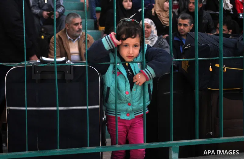 Palestinians wait for a travel permit to cross into Egypt through the Rafah border crossing between Egypt and the southern Gaza Strip February 14, 2016. Egypt opened the Rafah border crossing on Saturday for two days to...