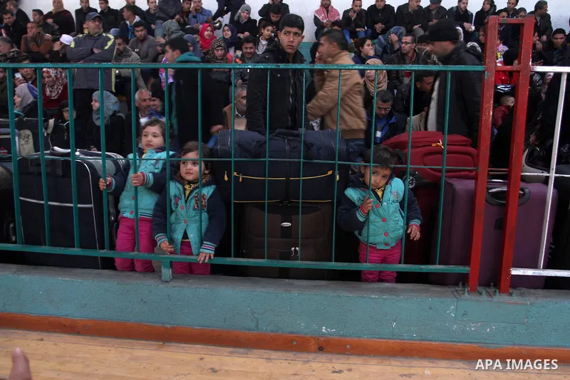 Palestinians wait for a travel permit to cross into Egypt through the Rafah border crossing between Egypt and the southern Gaza Strip February 14, 2016. Egypt opened the Rafah border crossing on Saturday for two days to...