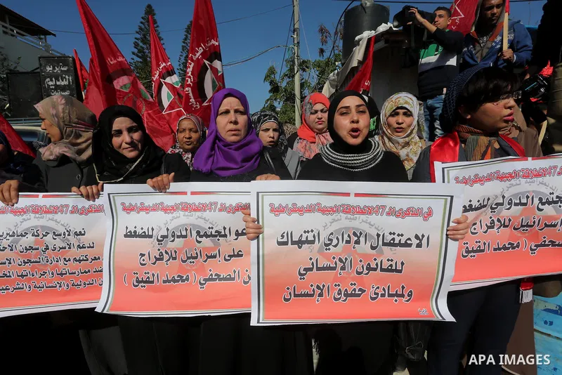 Palestinians hold posters during a protest in support of hunger striking Palestinian journalist Mohammed al-Qiq, in Gaza city on February 14, 2016. The 33-year-old television reporter will keep up his 10-week hunger stri...