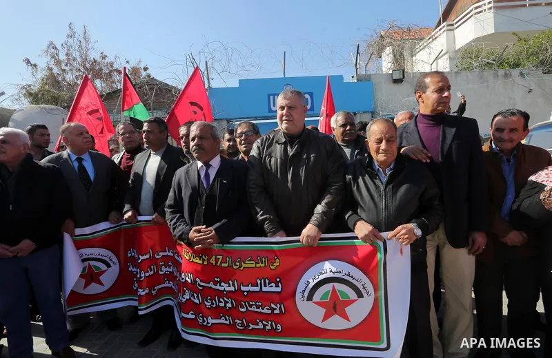 Palestinians hold posters during a protest in support of hunger striking Palestinian journalist Mohammed al-Qiq, in Gaza city on February 14, 2016. The 33-year-old television reporter will keep up his 10-week hunger stri...