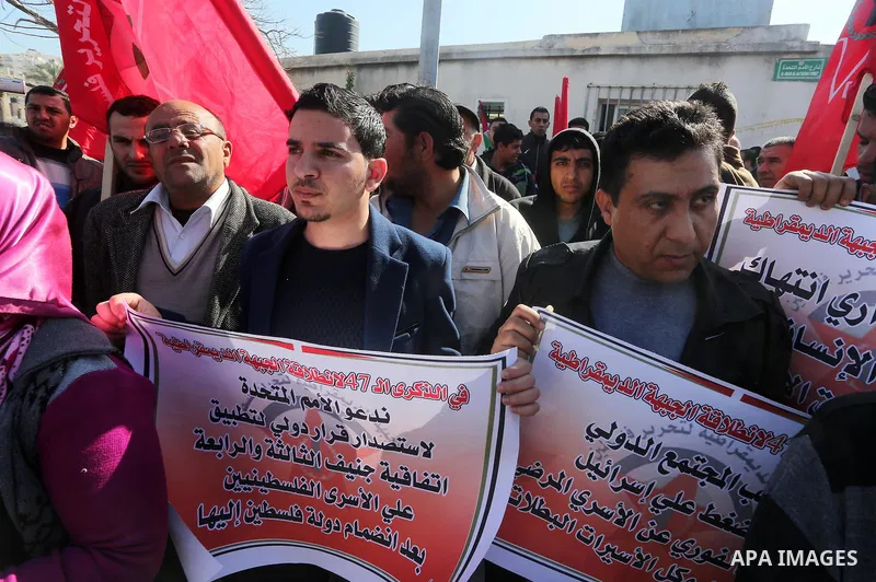 Palestinians hold posters during a protest in support of hunger striking Palestinian journalist Mohammed al-Qiq, in Gaza city on February 14, 2016. The 33-year-old television reporter will keep up his 10-week hunger stri...