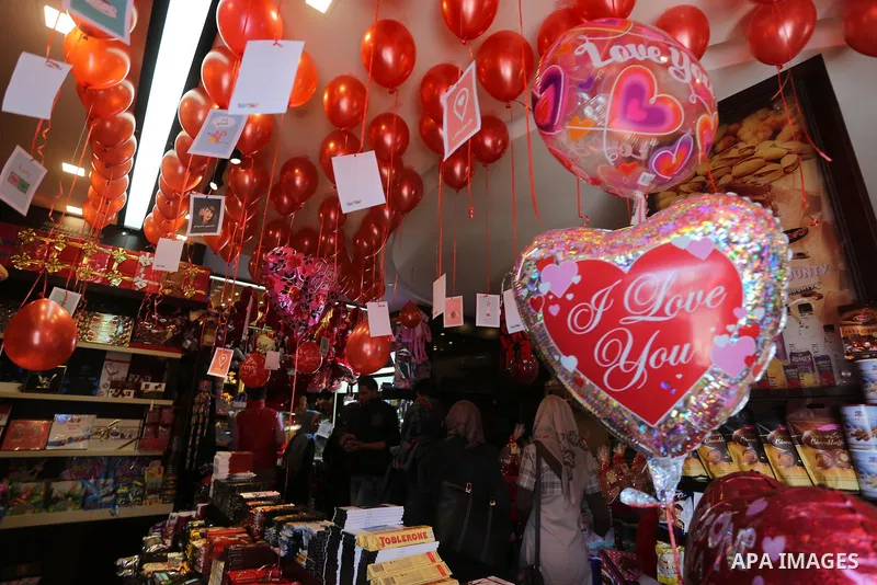Palestinian vendors display flowers red teddy bears and pillows on Valentine's day in Gaza on February 14, 2016. Valentine's Day is increasingly popular in the region as people have taken up the custom of giving flowers,...