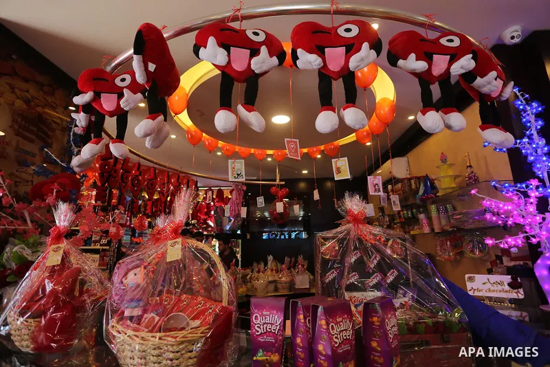 Palestinian vendors display flowers red teddy bears and pillows on Valentine's day in Gaza on February 14, 2016. Valentine's Day is increasingly popular in the region as people have taken up the custom of giving flowers,...
