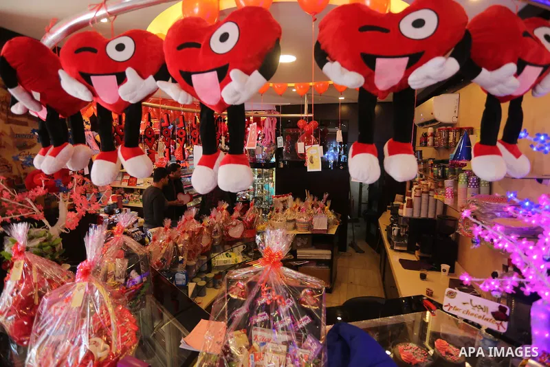 Palestinian vendors display flowers red teddy bears and pillows on Valentine's day in Gaza on February 14, 2016. Valentine's Day is increasingly popular in the region as people have taken up the custom of giving flowers,...