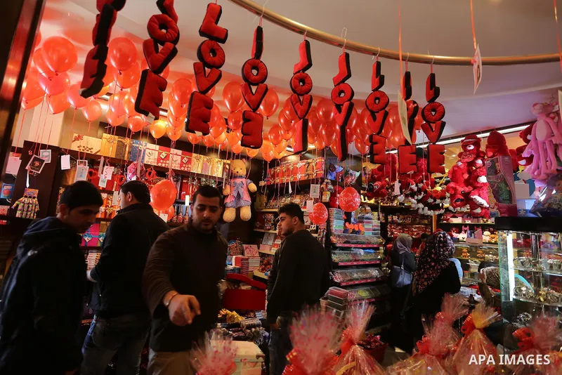 Palestinian vendors display flowers red teddy bears and pillows on Valentine's day in Gaza on February 14, 2016. Valentine's Day is increasingly popular in the region as people have taken up the custom of giving flowers,...