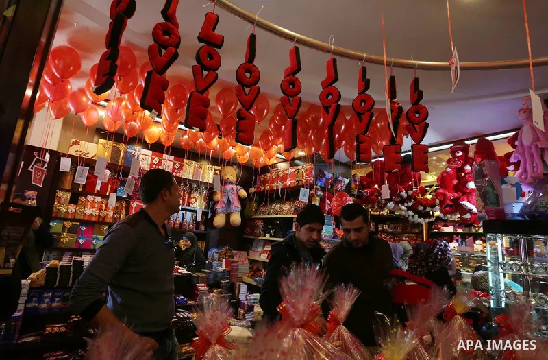 Palestinian vendors display flowers red teddy bears and pillows on Valentine's day in Gaza on February 14, 2016. Valentine's Day is increasingly popular in the region as people have taken up the custom of giving flowers,...