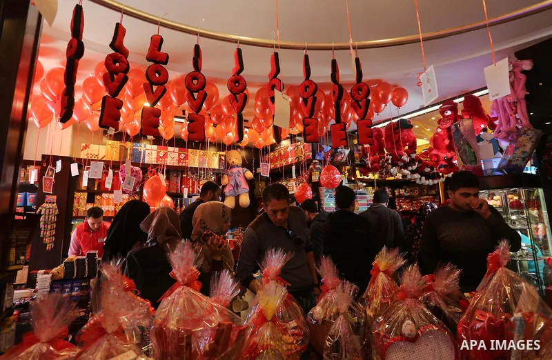 Palestinian vendors display flowers red teddy bears and pillows on Valentine's day in Gaza on February 14, 2016. Valentine's Day is increasingly popular in the region as people have taken up the custom of giving flowers,...