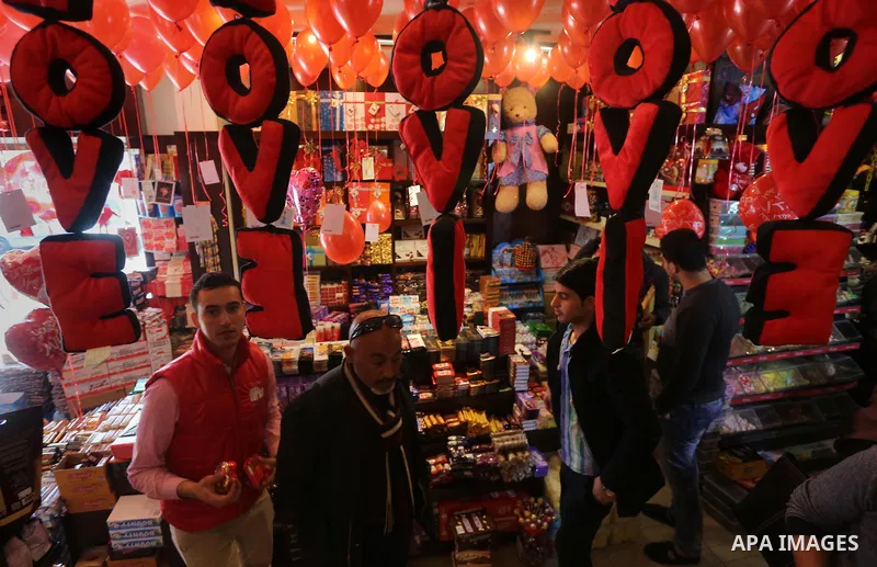 Palestinian vendors display flowers red teddy bears and pillows on Valentine's day in Gaza on February 14, 2016. Valentine's Day is increasingly popular in the region as people have taken up the custom of giving flowers,...