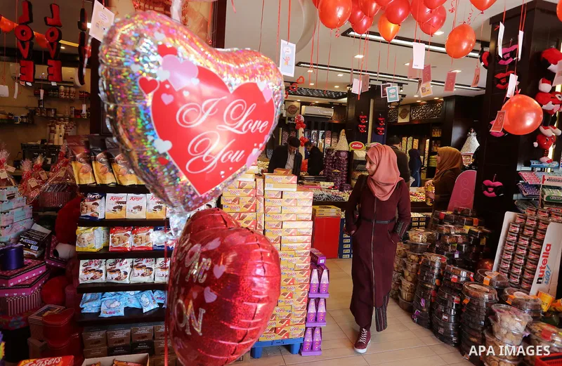 Palestinian vendors display flowers red teddy bears and pillows on Valentine's day in Gaza on February 14, 2016. Valentine's Day is increasingly popular in the region as people have taken up the custom of giving flowers,...