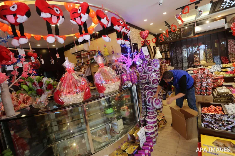 Palestinian vendors display flowers red teddy bears and pillows on Valentine's day in Gaza on February 14, 2016. Valentine's Day is increasingly popular in the region as people have taken up the custom of giving flowers,...