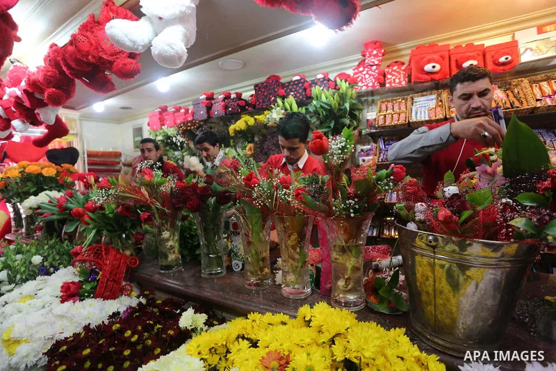Palestinian vendors display flowers red teddy bears and pillows on Valentine's day in Gaza on February 14, 2016. Valentine's Day is increasingly popular in the region as people have taken up the custom of giving flowers,...