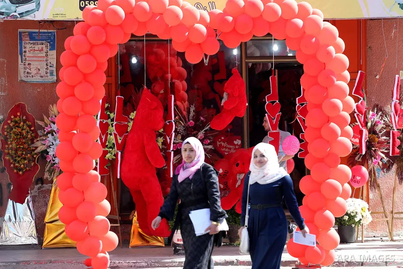 Palestinian vendors display flowers red teddy bears and pillows on Valentine's day in Gaza on February 14, 2016. Valentine's Day is increasingly popular in the region as people have taken up the custom of giving flowers,...
